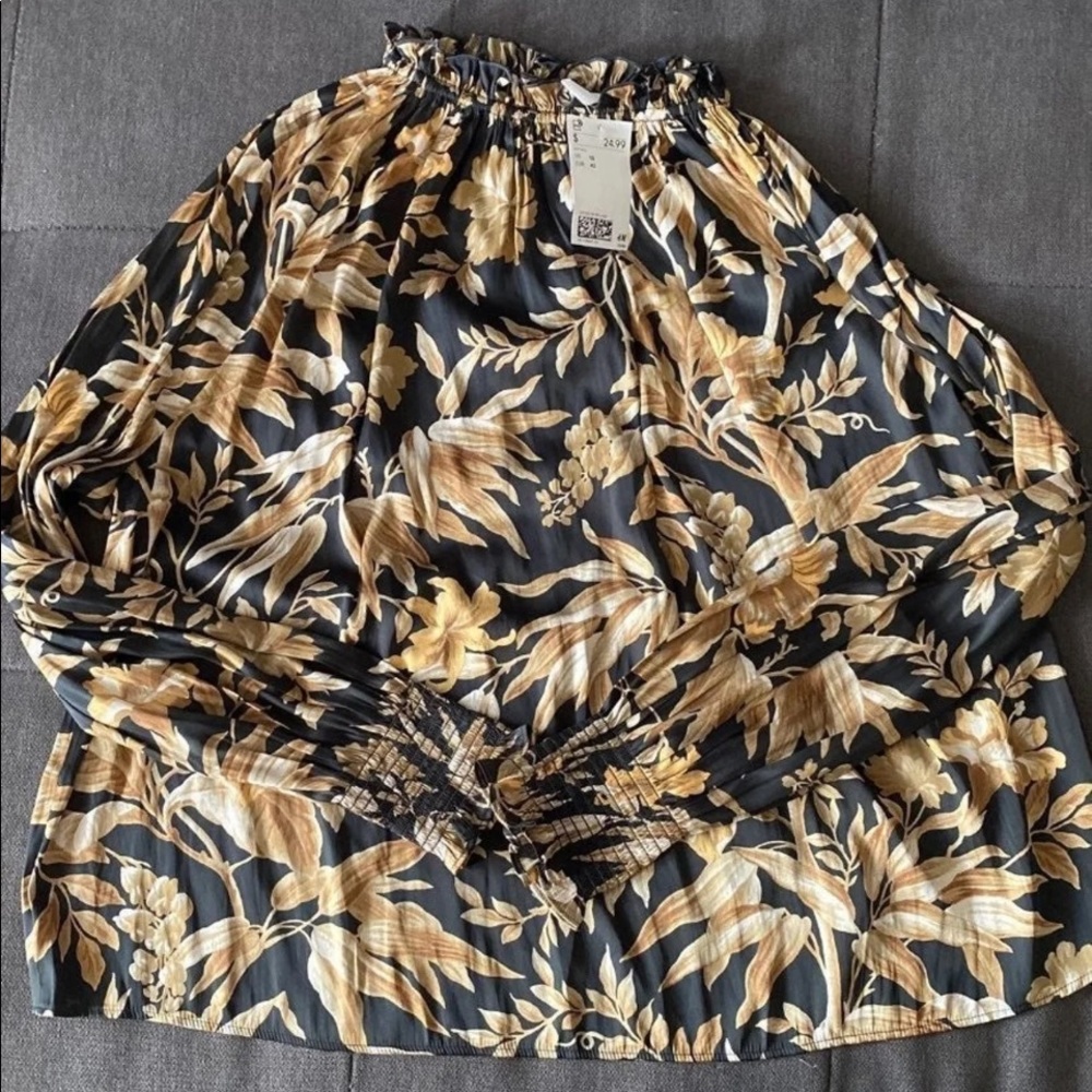H&M black floral/leaf patterned blouse with smocked ruffle neckline.